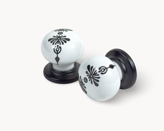 Belnua - ZERRA knob with midnight blossom motif on white ceramic/porcelain and matte black base