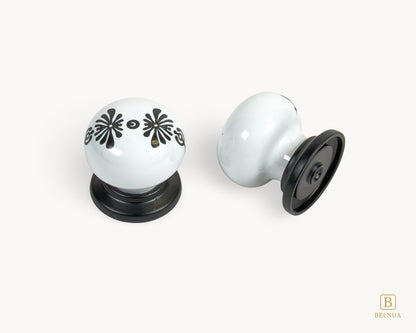 Belnua - Top and back view of ZERRA knob with midnight blossom motif on white porcelain/ceramic and matte black base