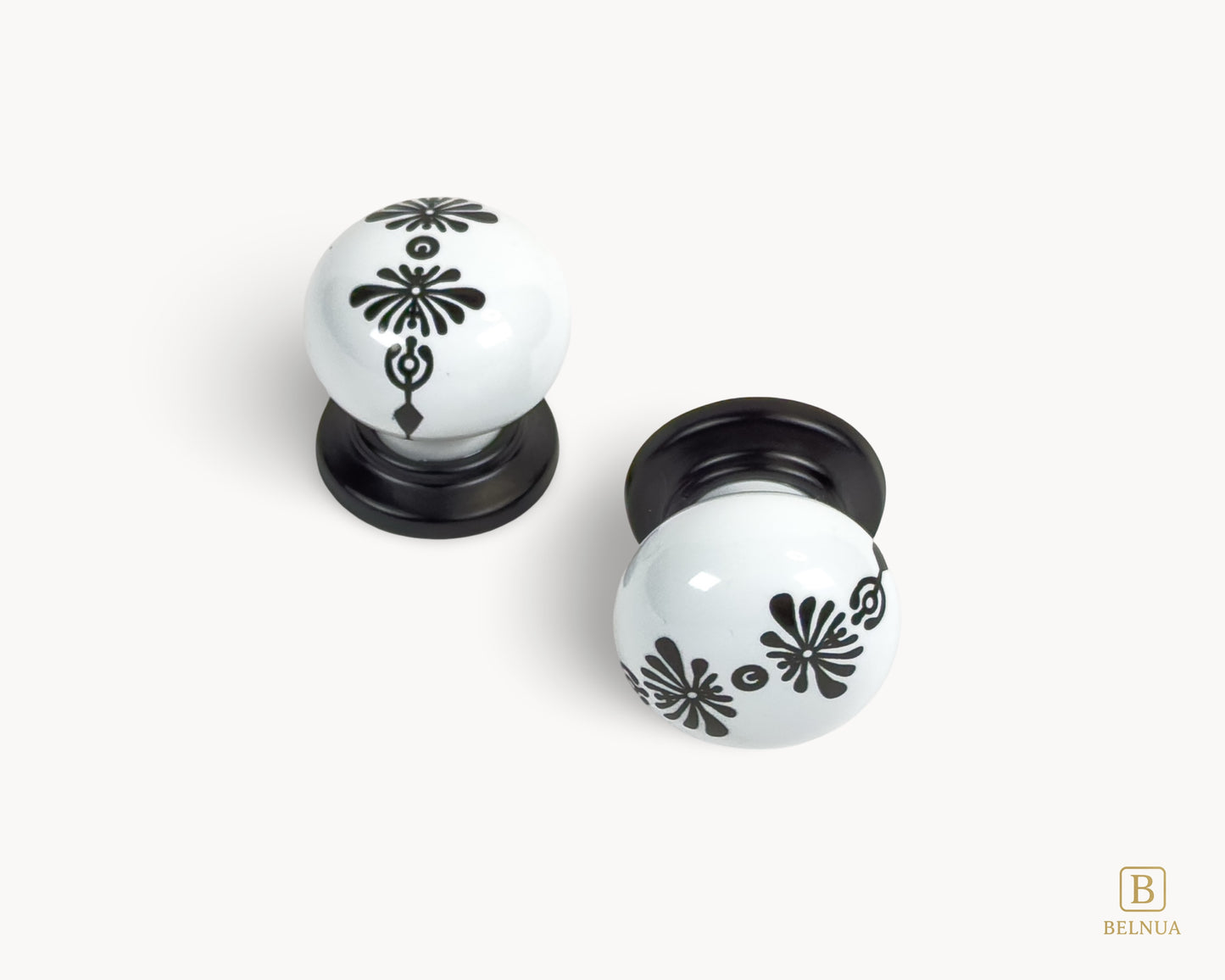 Belnua - Top and front view of ZERRA knob with midnight blossom motif on white porcelain/ceramic and matte black base