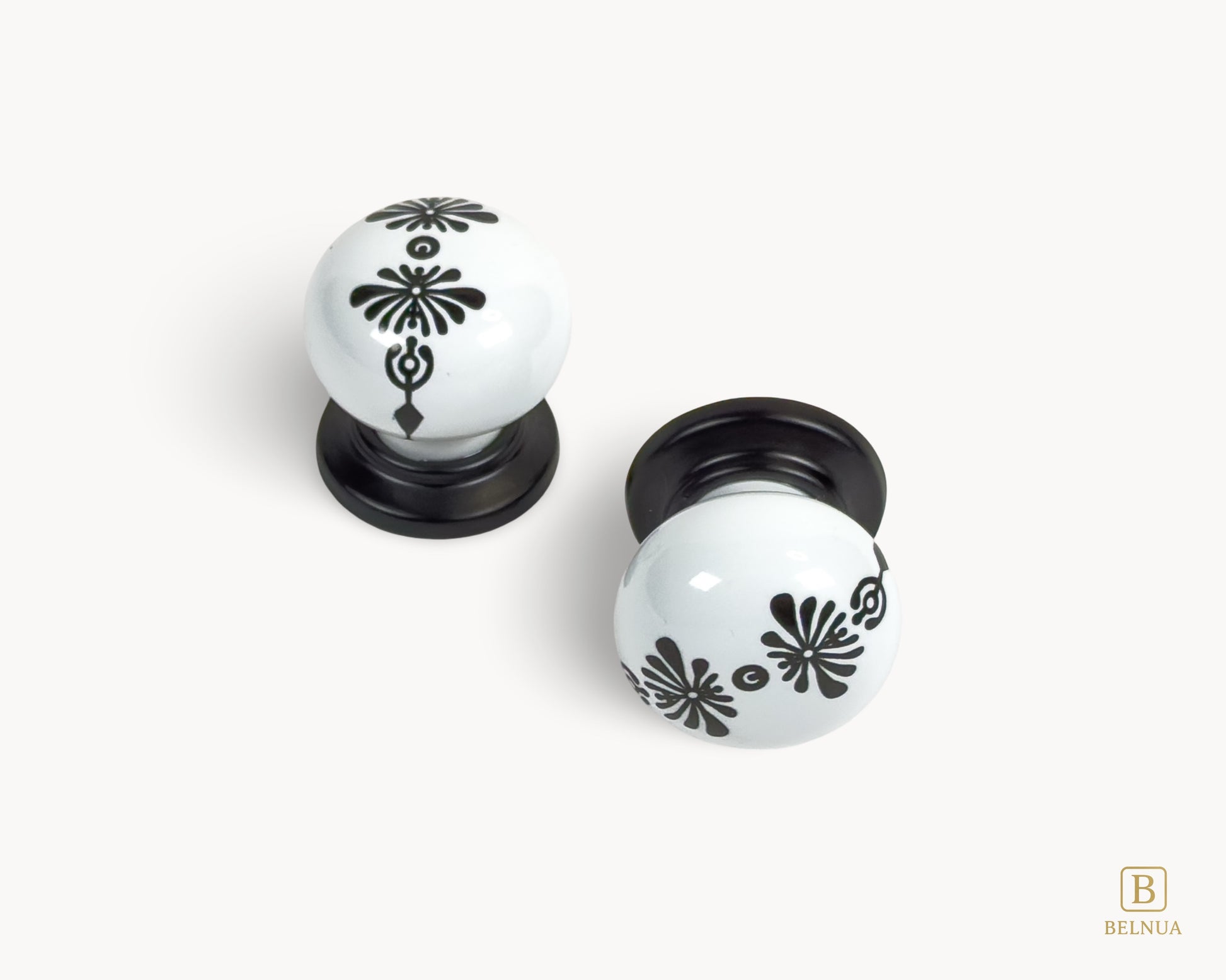 Belnua - Top and front view of ZERRA knob with midnight blossom motif on white porcelain/ceramic and matte black base