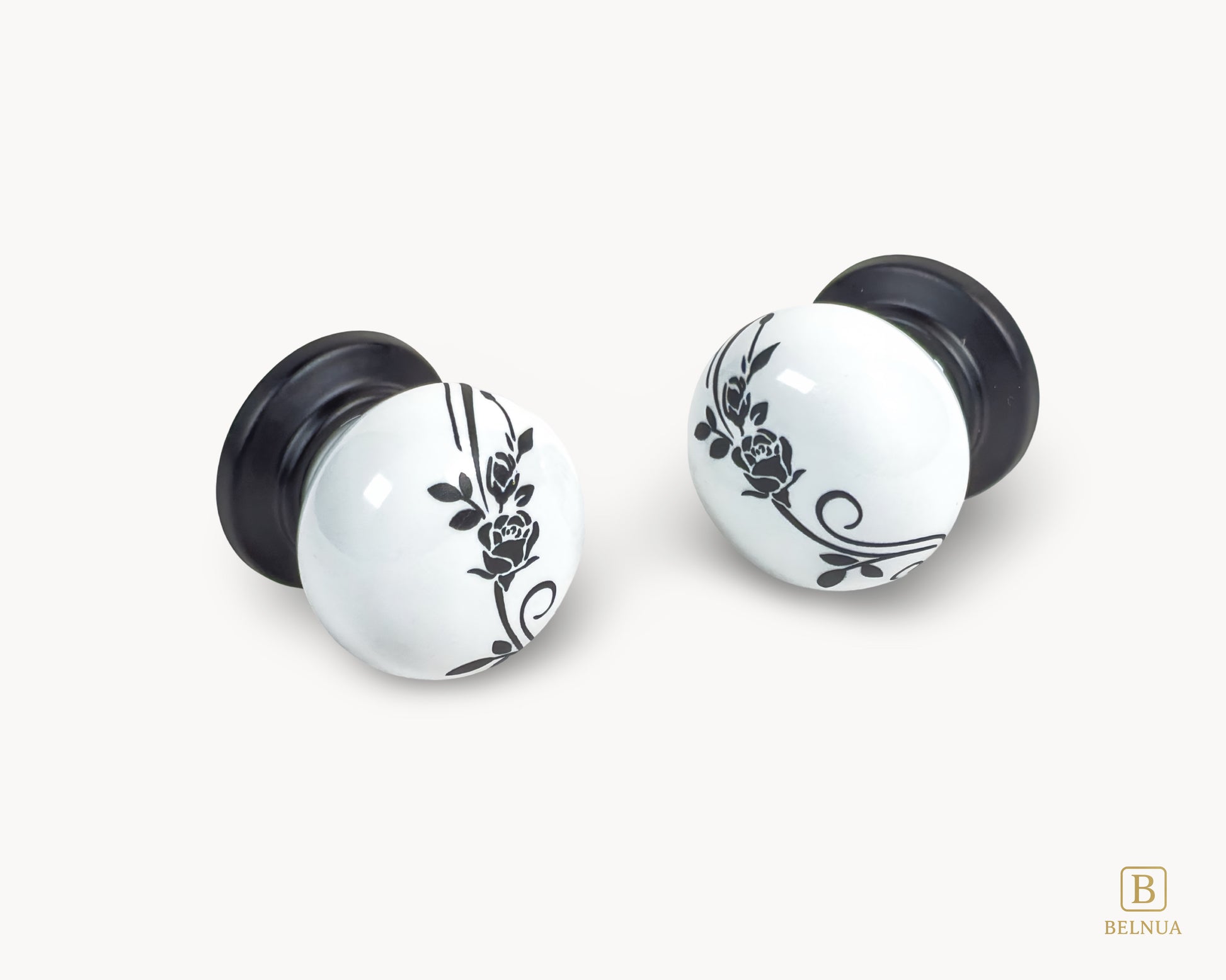 Belnua - Flat lay close up view of ZERRA matte black white knob with delicate botanical porcelain motif