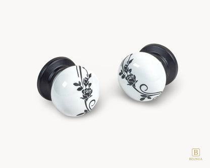 Belnua - Flat lay close up view of ZERRA matte black white knob with delicate botanical porcelain motif