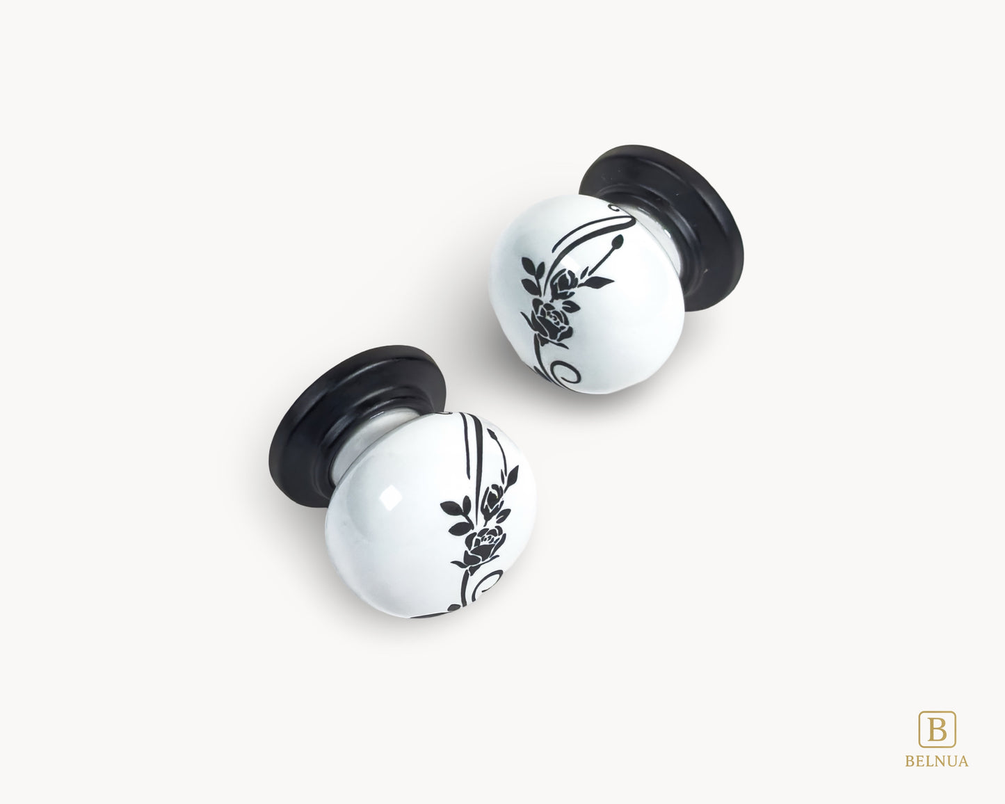 Belnua - Close up flat lay front view of ZERRA white ceramic/porcelain knob showing floral design with matte black base