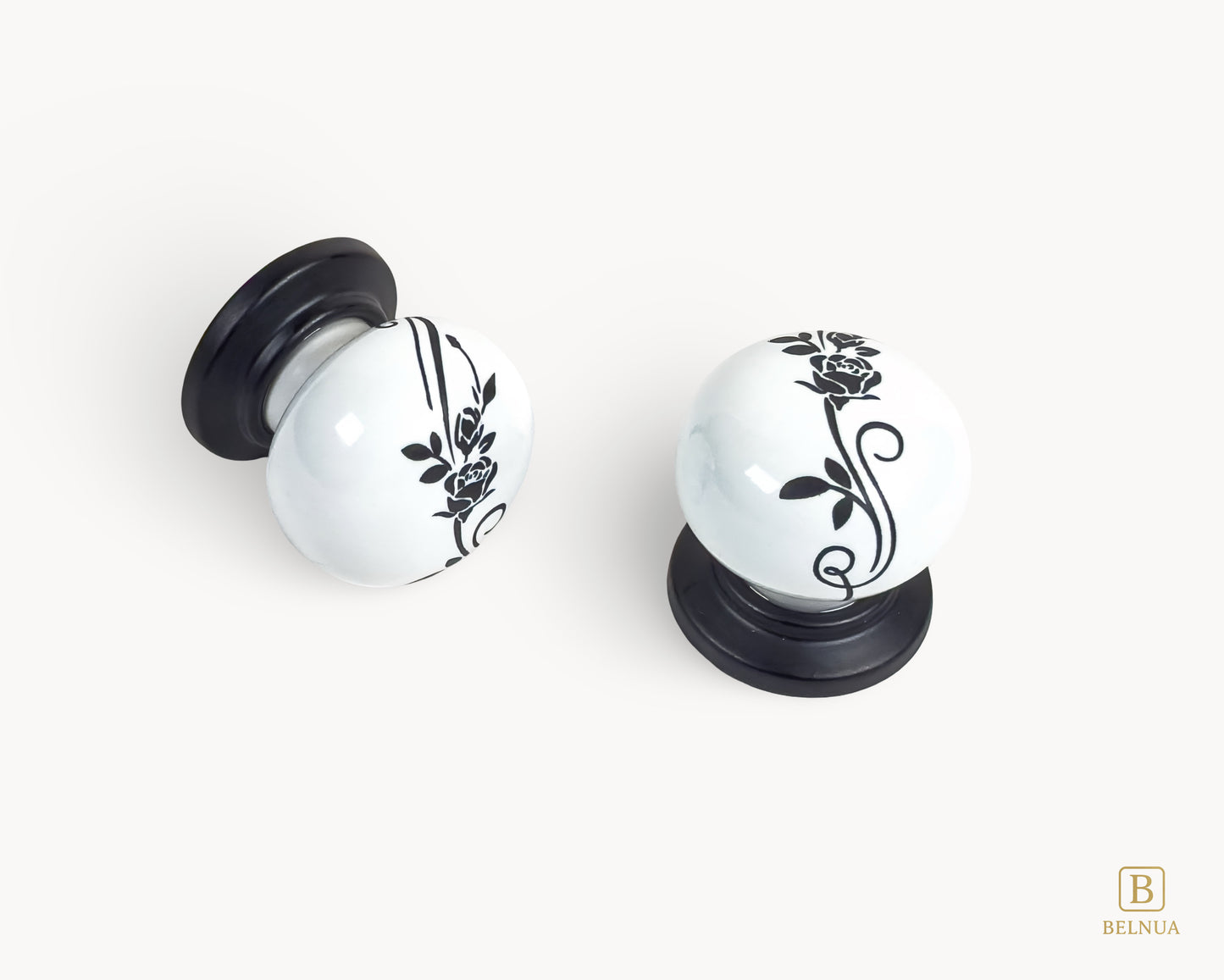 Belnua - Close up top and left flat lay view of ZERRA white ceramic/porcelain knob showing floral design with matte black base