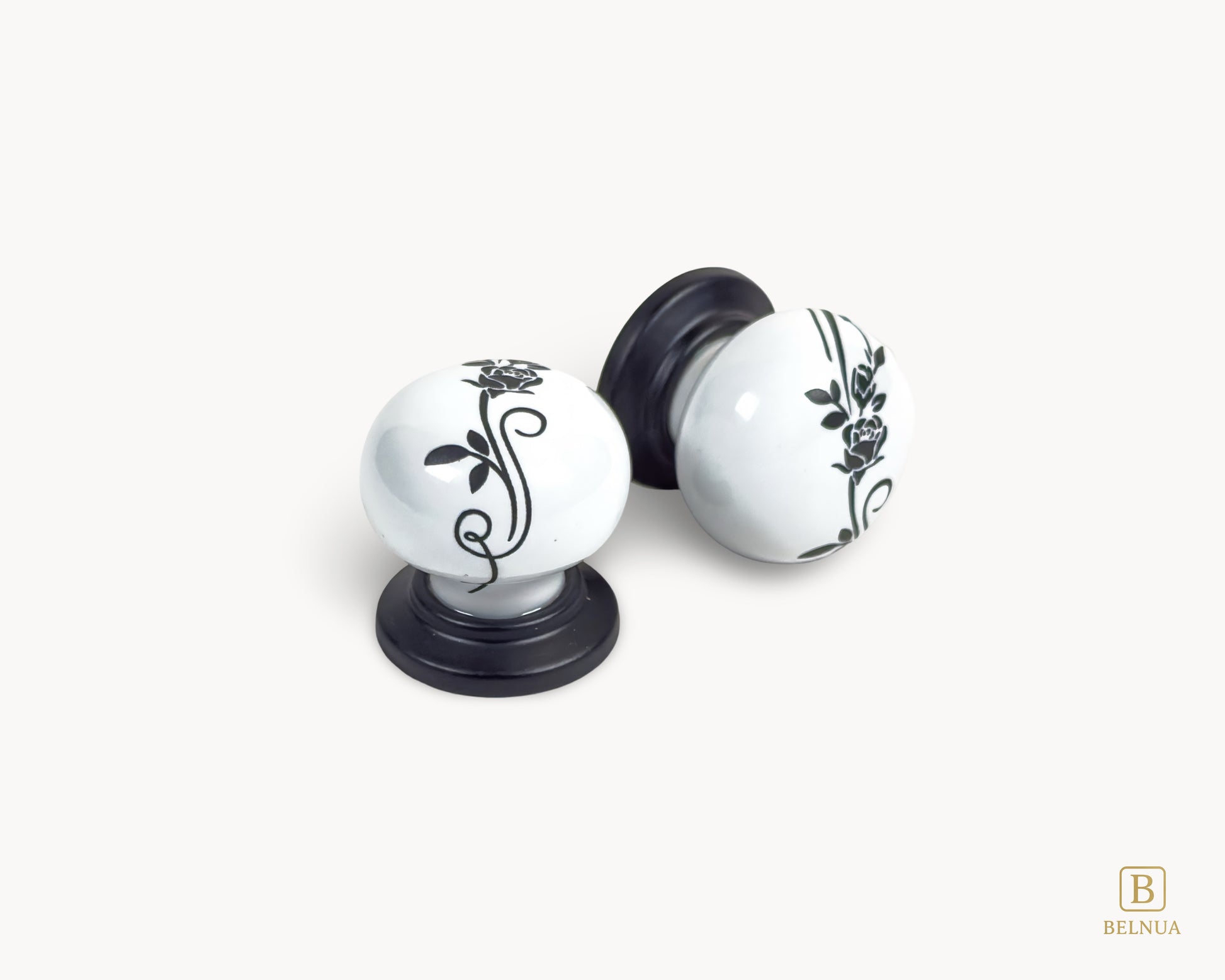 Belnua - Close up top and right flat lay view of ZERRA white ceramic/porcelain knob showing floral design with matte black base