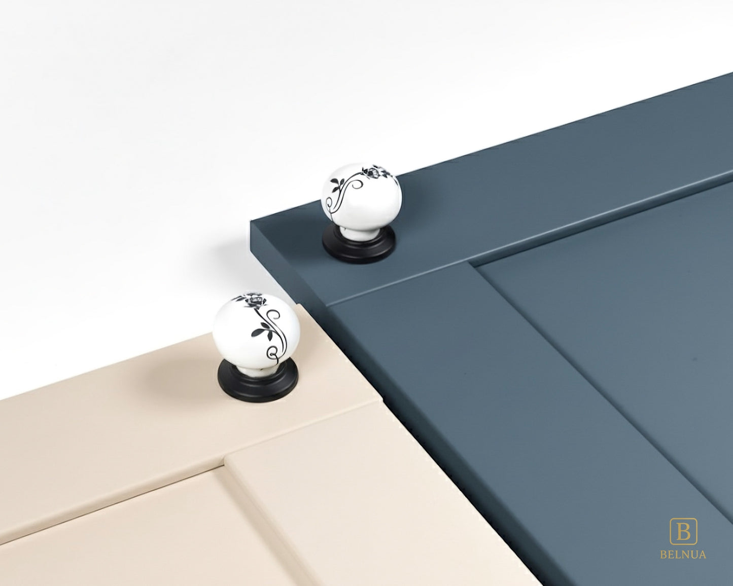 Belnua - ZERRA porcelain/ceramic white knob with botanical motif on black base showcasing with cream & navy blue cabinet door