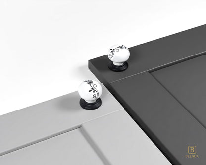 Belnua - ZERRA porcelain/ceramic white knob with botanical motif on black base showcasing with light & charcoal grey cabinet door