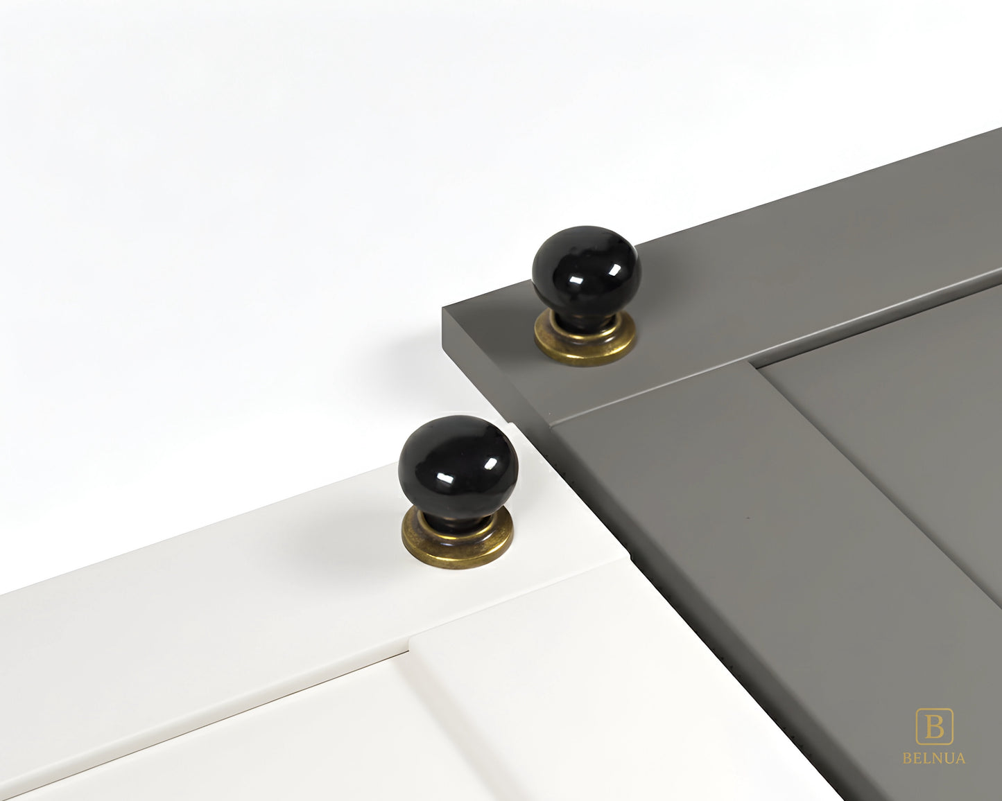 Close-up of a porcelain white and gray cabinet door with black knobs and brass bases from Zerra collection | Belnua