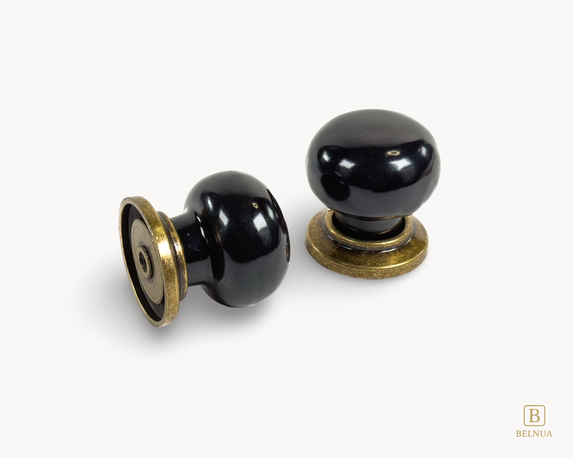 Top and back view of Zerra black ceramic cabinet knobs with brass base | Belnua