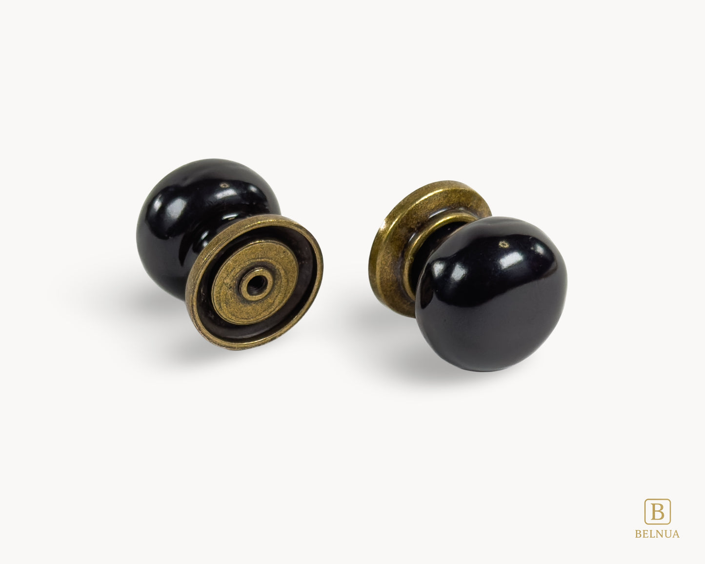 Pair of Zerra black porcelain cabinet knobs in flatlay view | Belnua
