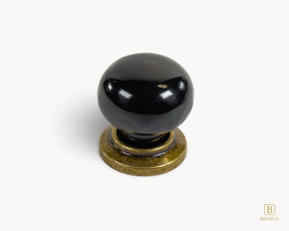 Top view of Zerra black porcelain knob and brass base | Belnua