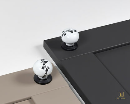 Belnua - Styled cashmere and charcoal grey cabinet door featuring ZERRA black leaf porcelain knob