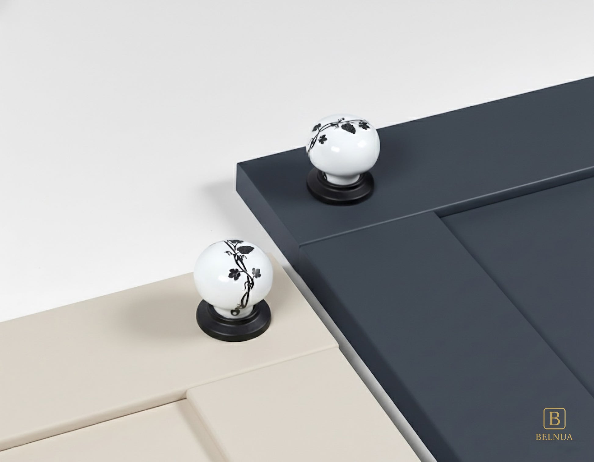 Belnua - Styled cream and navy blue cabinet door featuring ZERRA black leaf porcelain knob