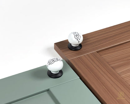 Belnua - ZERRA porcelain/ceramic white knob with ink petal motif on sage green and walnut wood grain cabinet door