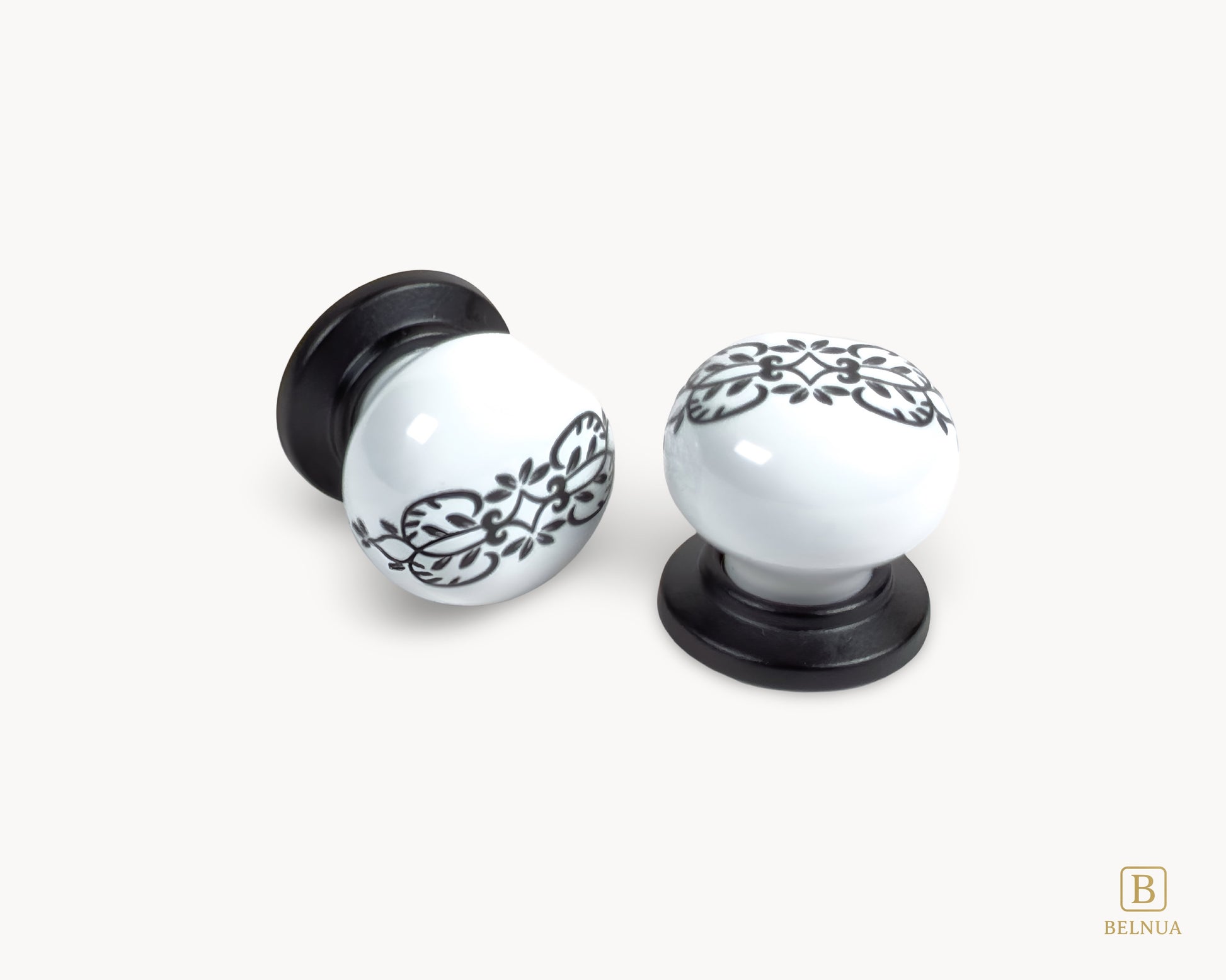 Belnua - Pair of ZERRA white cabinet knobs with black floral patterns with flat lay view