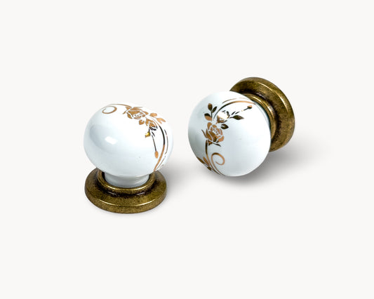 Belnua - ZERRA white ceramic/porcelain knob with golden scroll motif and antique brass base