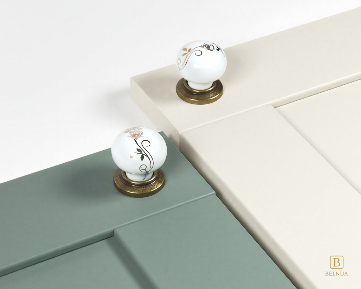 Belnua - ZERRA porcelain/ceramic white knob with golden scroll motif with antique brass base on sage green and cream cabinet door
