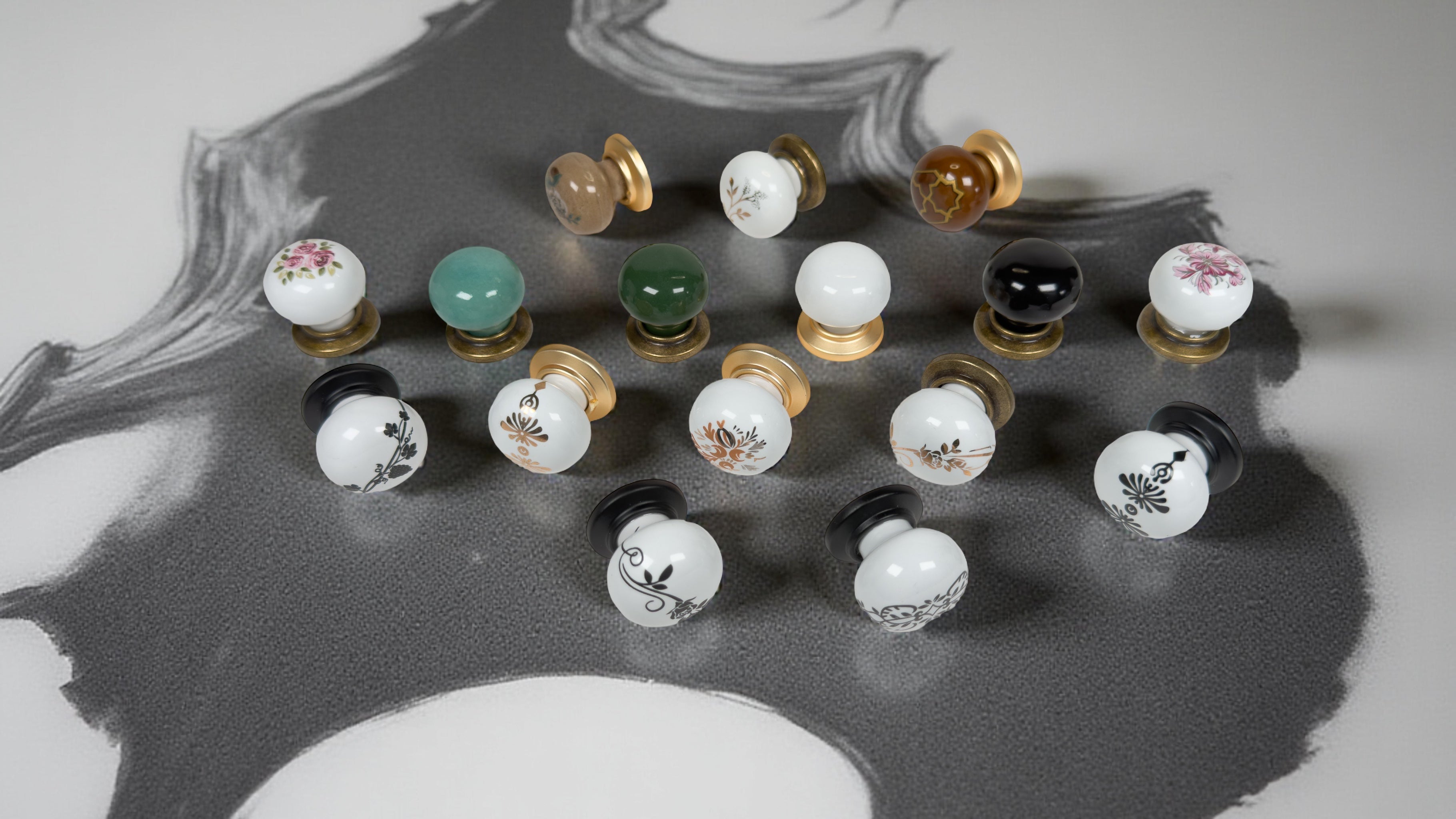Decorative Belnua ZERRA porcelain cabinet knobs in mixed finishes—antique brass, matte black and matte gold—with porcelain colours in black, white, green, brown and turquoise, featuring detailed floral motifs.