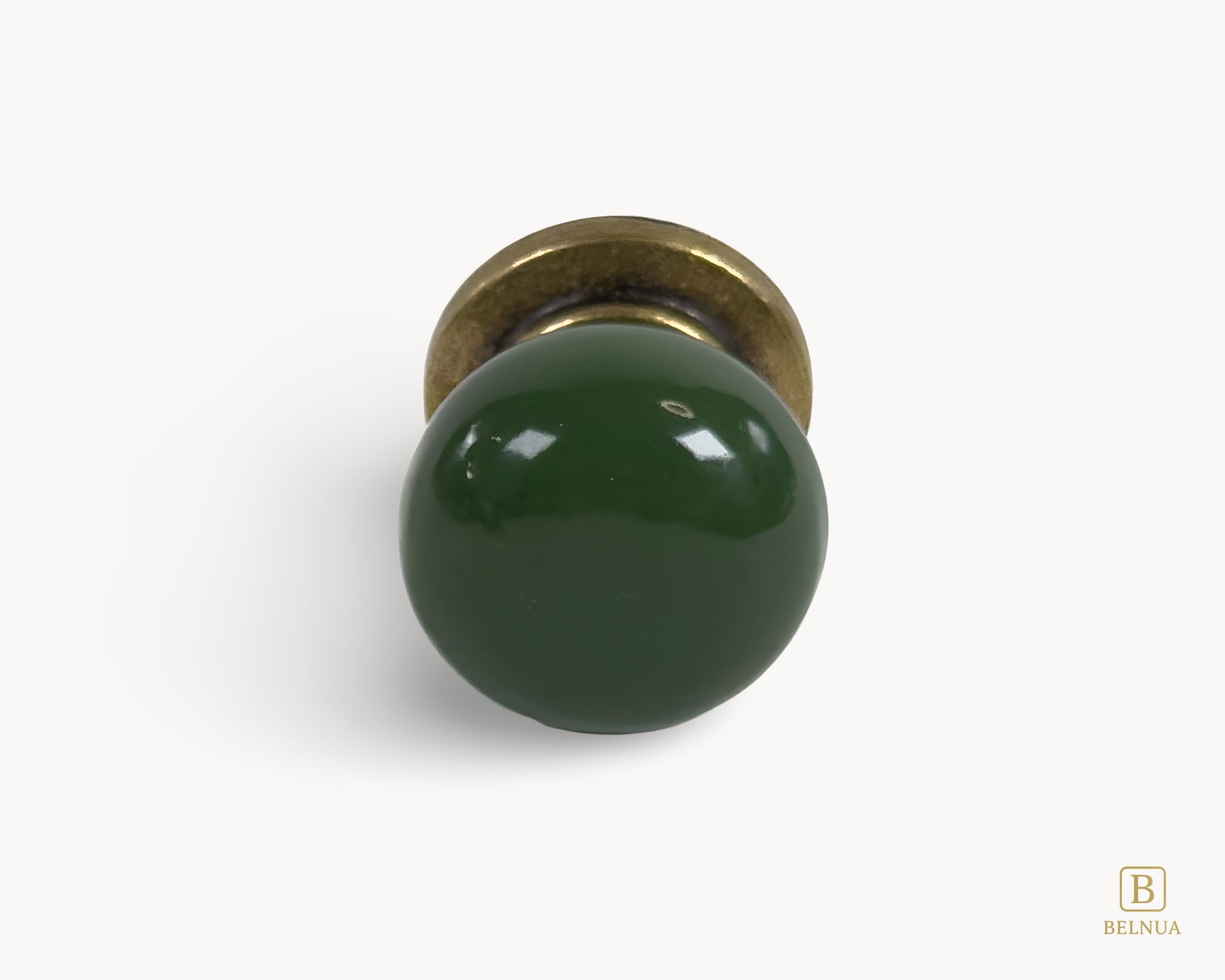 Belnua - Front flat lay of antique brass knob with dark green porcelain insert from Zerra collection