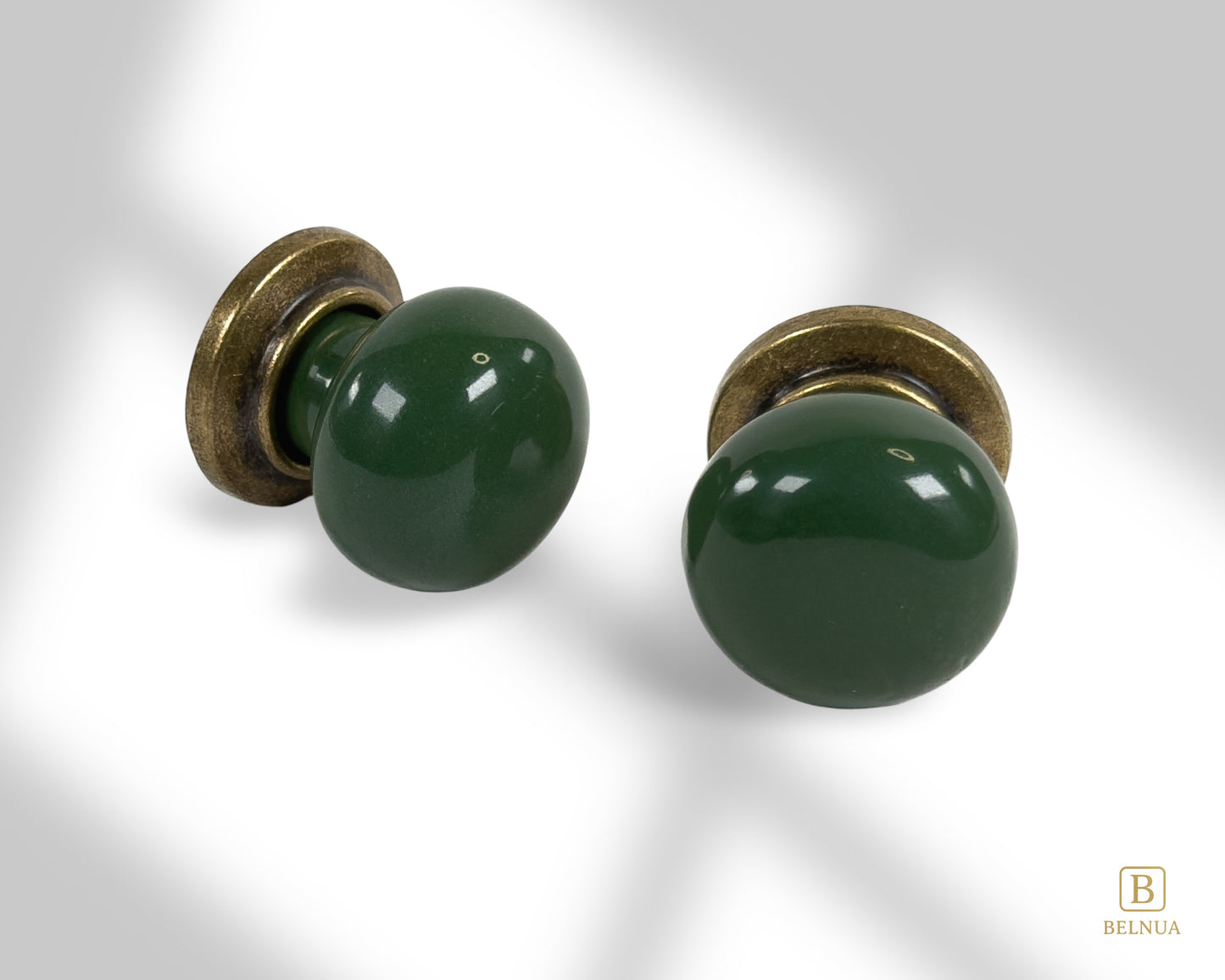 Belnua - Pair of flat lay of antique brass knob with dark green porcelain insert with shadow view