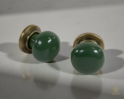 Belnua - Pair of flat lay of antique brass knob with dark green porcelain insert with grey background