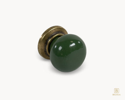 Belnua - Right angled flat lay of antique brass knob with dark green porcelain insert from Zerra collection