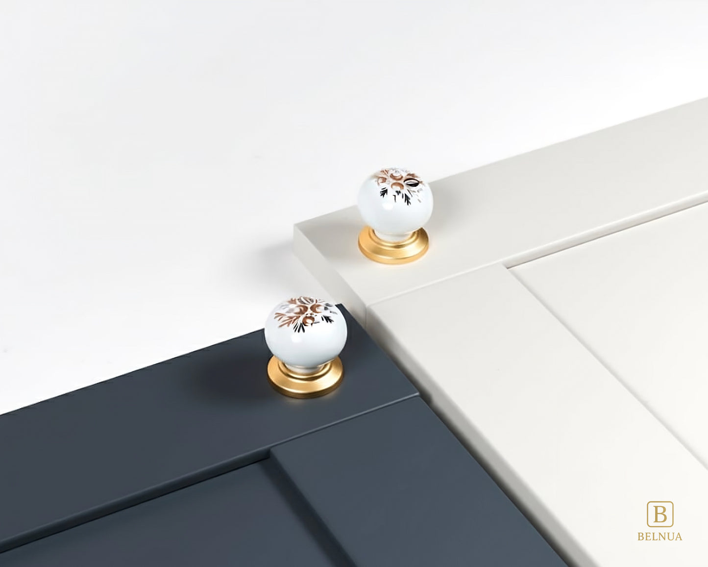 Belnua - ZERRA porcelain/ceramic white knob with golden arch bloom motif showcasing with deep navy and cream cabinet door