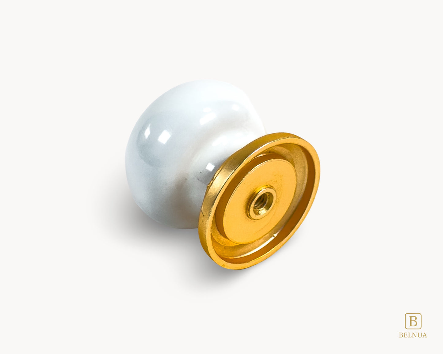 Belnua - Flat lay detailed back view of ZERRA white cabinet porcelain/ceramic knob with matte gold finish and golden arch motif showing fixing hole