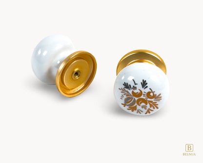 Belnua - Back and top flat lay view of delicate ZERRA white cabinet porcelain/ceramic knob with matte gold finish and golden arch motif