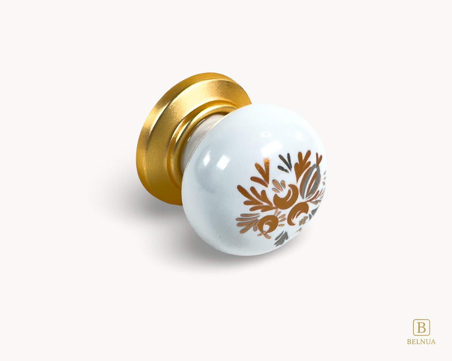 Belnua - Flat lay detailed right side view of delicate ZERRA white cabinet porcelain/ceramic knob with matte gold finish and golden arch motif