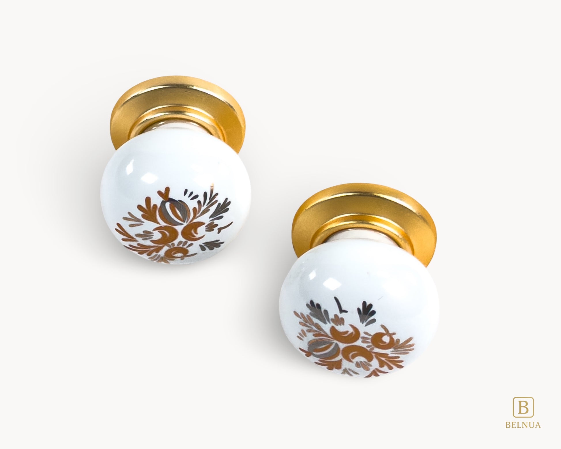Belnua - ZERRA white porcelain/ceramic cabinet knob in matte gold with golden arch bloom motif