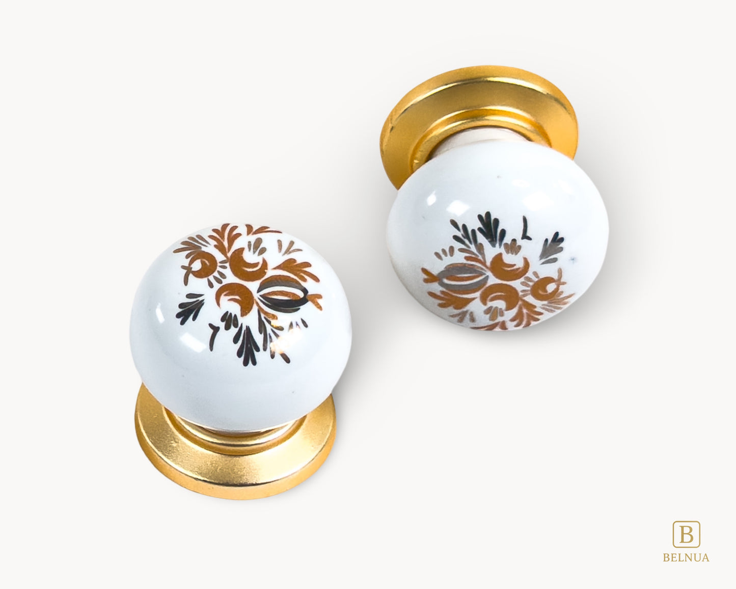Belnua - pair of ZERRA cabinet knob top and flat lay front showing detail of floral arch pattern on white porcelain/ceramic insert