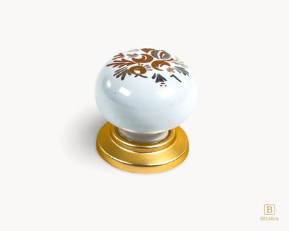 Belnua - Delicate ZERRA white cabinet porcelain/ceramic knob with matte gold finish and golden arch motif with close up top view
