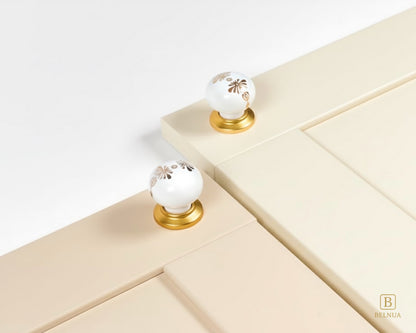 Belnua - ZERRA porcelain/ceramic knob with golden blossom motif on cream & cashmere cabinet door