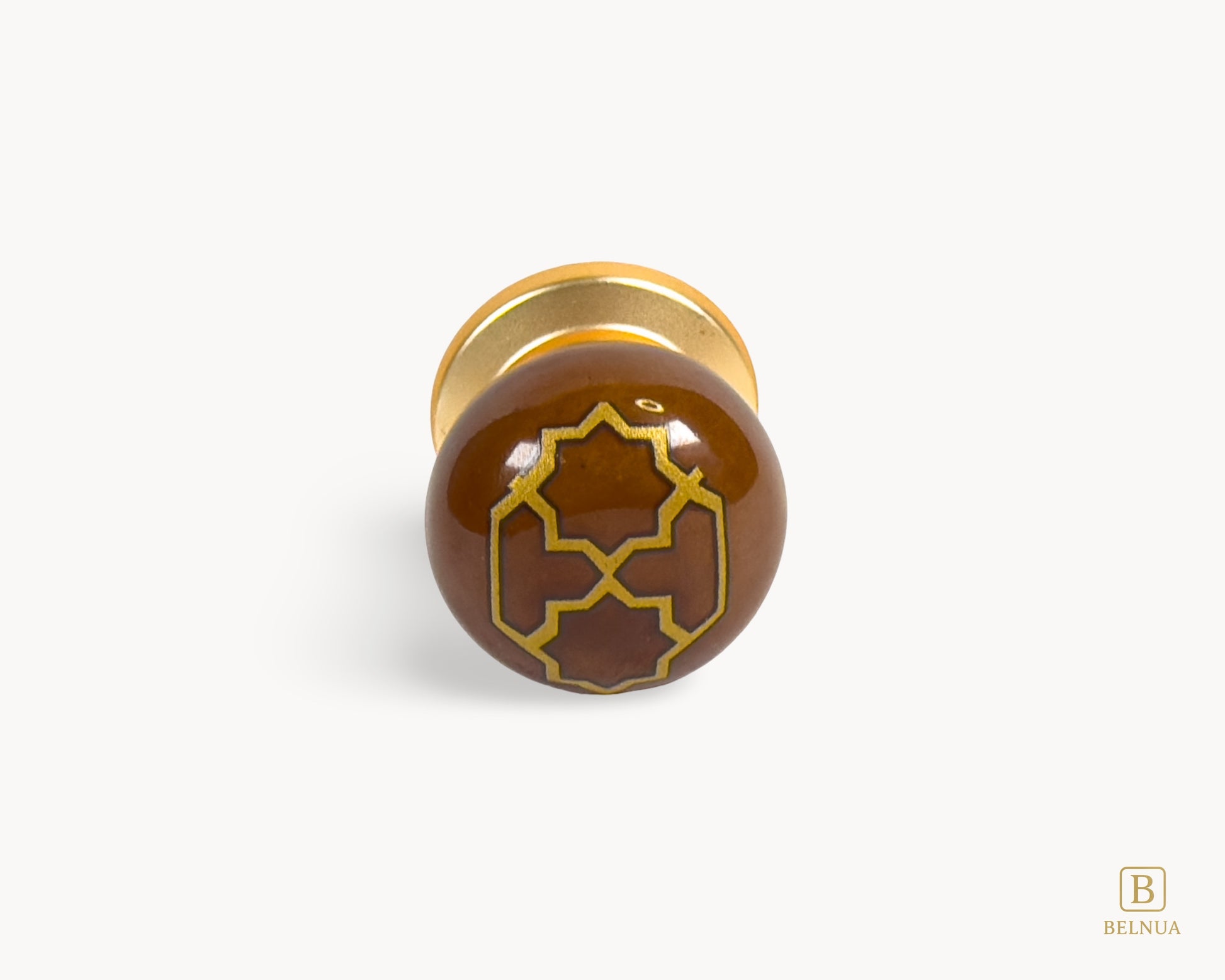 Belnua - Front flat lay view of ZERRA golden tile knob on brown porcelain insert white background
