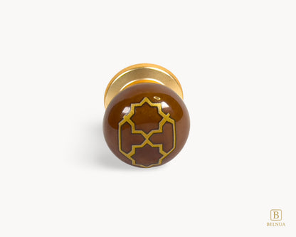 Belnua - Front flat lay view of ZERRA golden tile knob on brown porcelain insert white background
