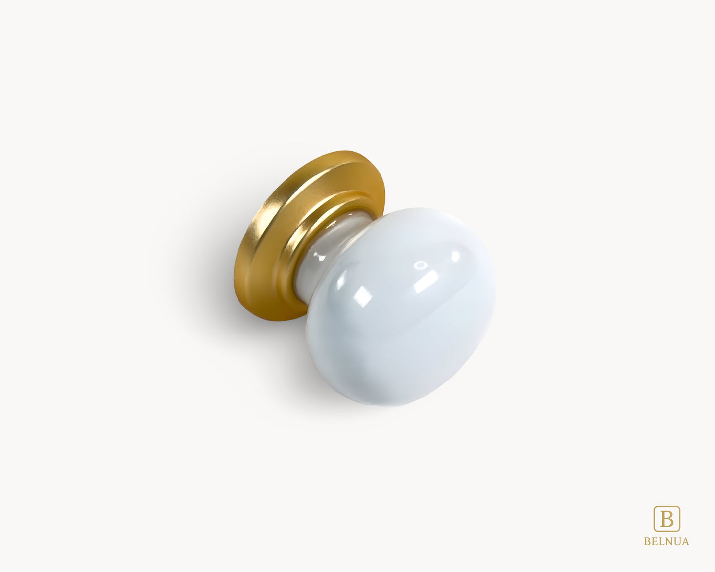 Angled flat lay view of Zerra white porcelain / ceramic knob with gold base | Belnua