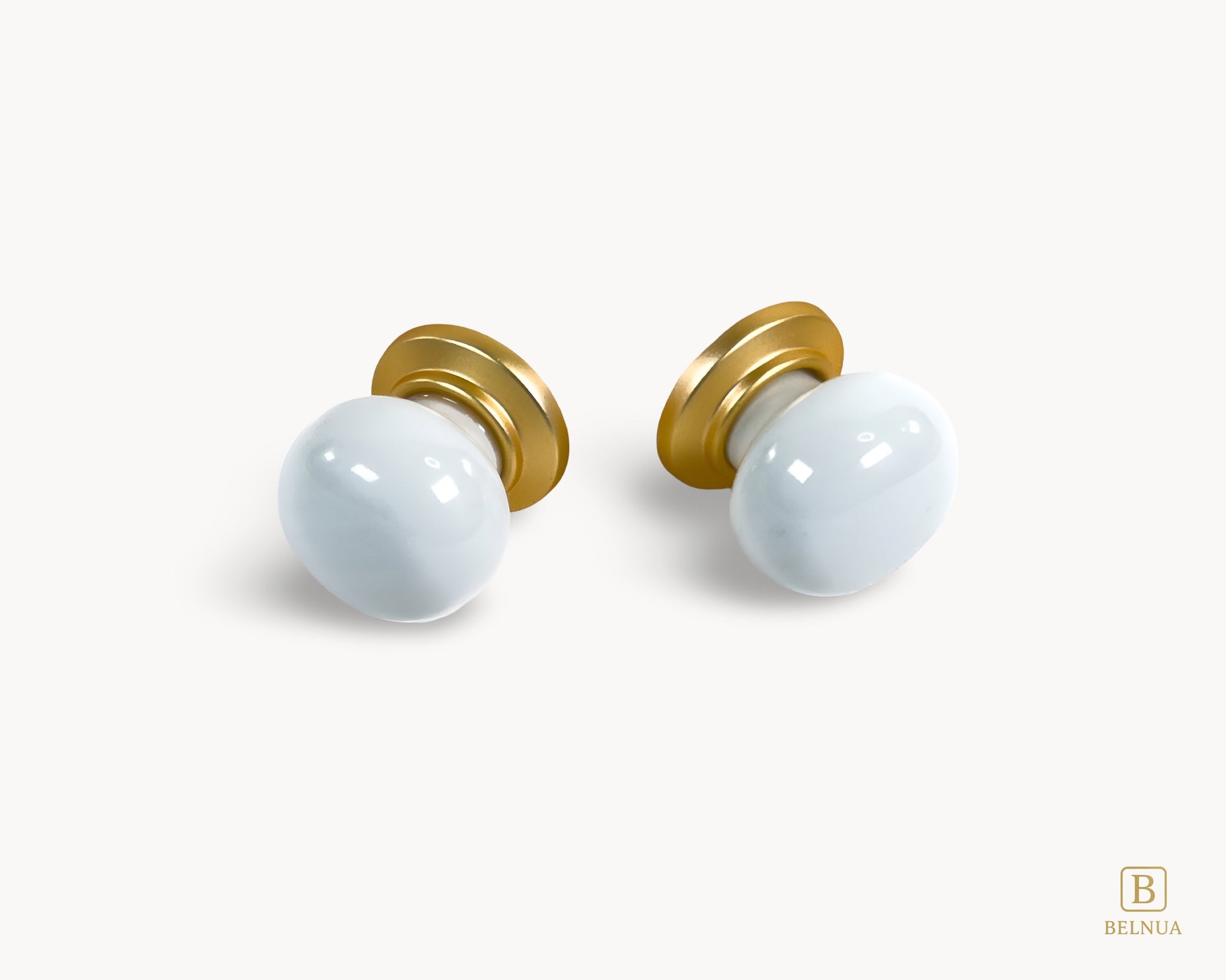 Front angled flat lay view of Zerra white porcelain knob with gold base | Belnua