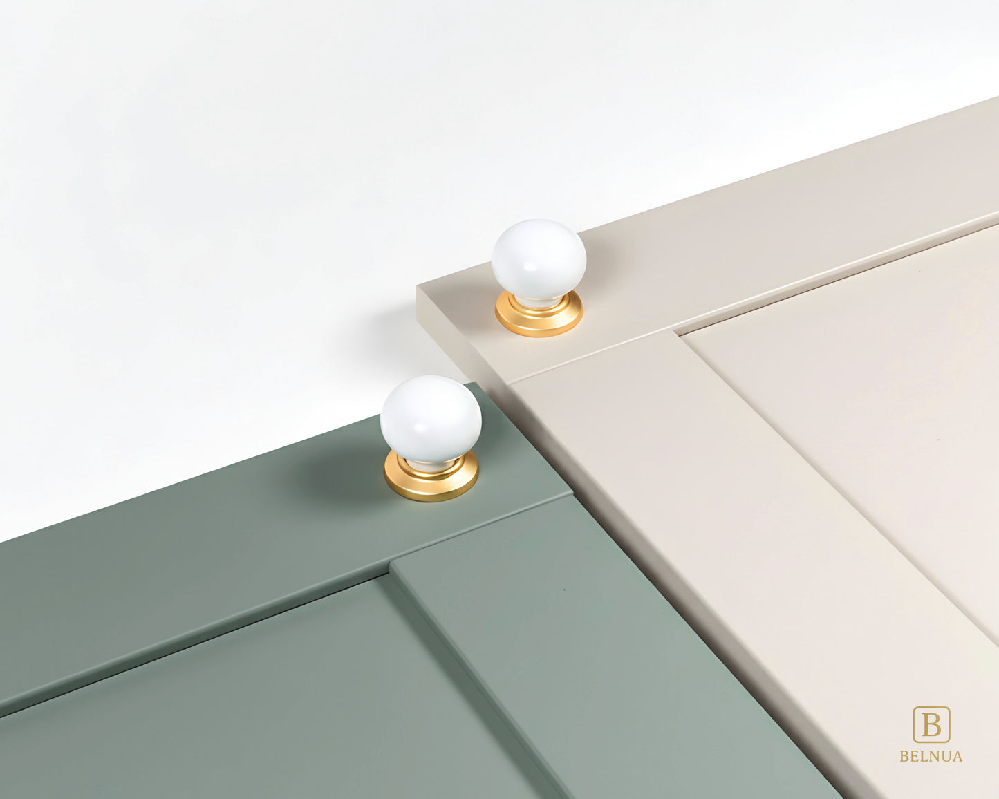 Close-up of a sage green and cashmere cabinet doors with Zerra white ceramic knobs and gold bases | Belnua