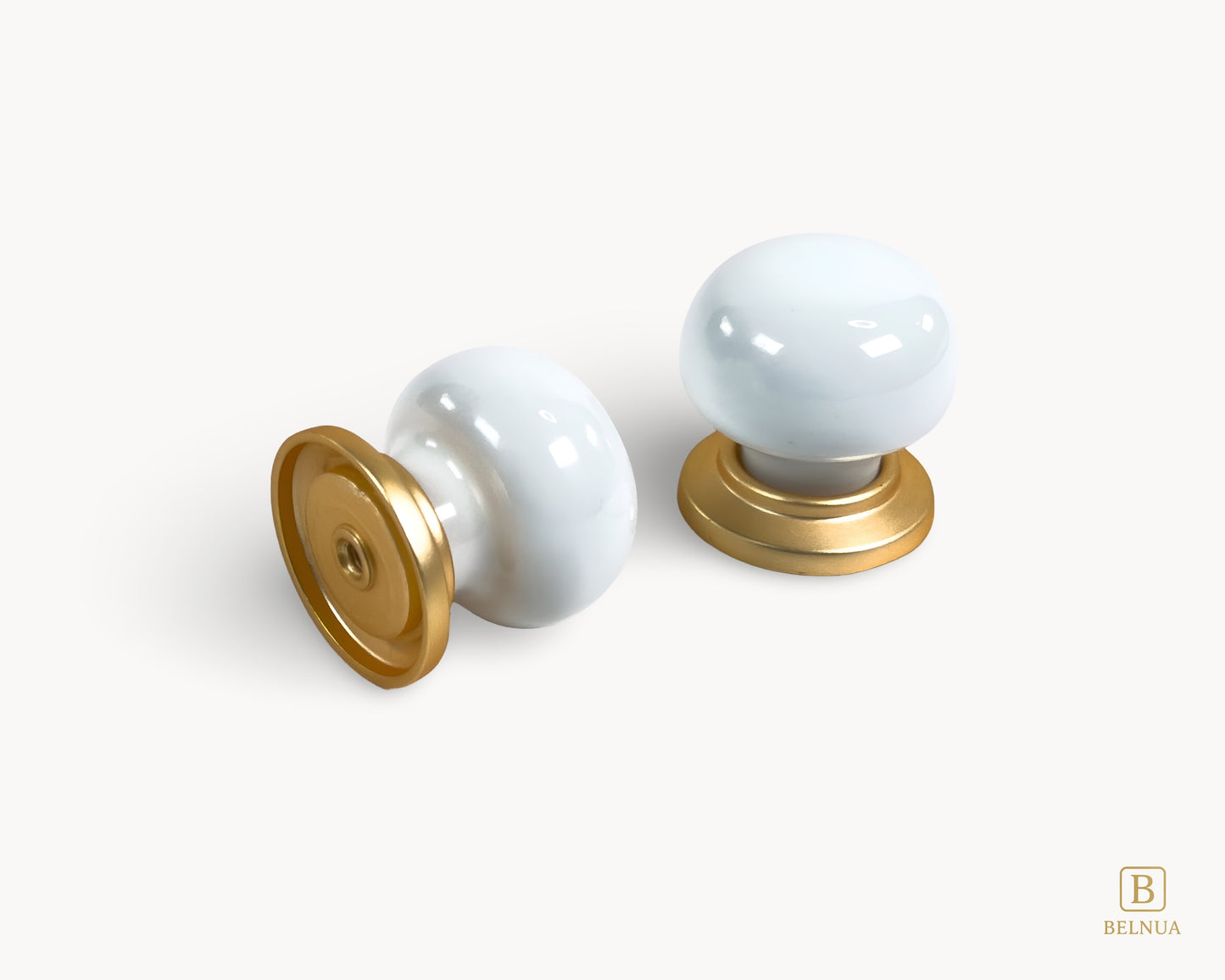 Angled back and top view of two Zerra white porcelain / ceramic knobs with gold base | Belnua