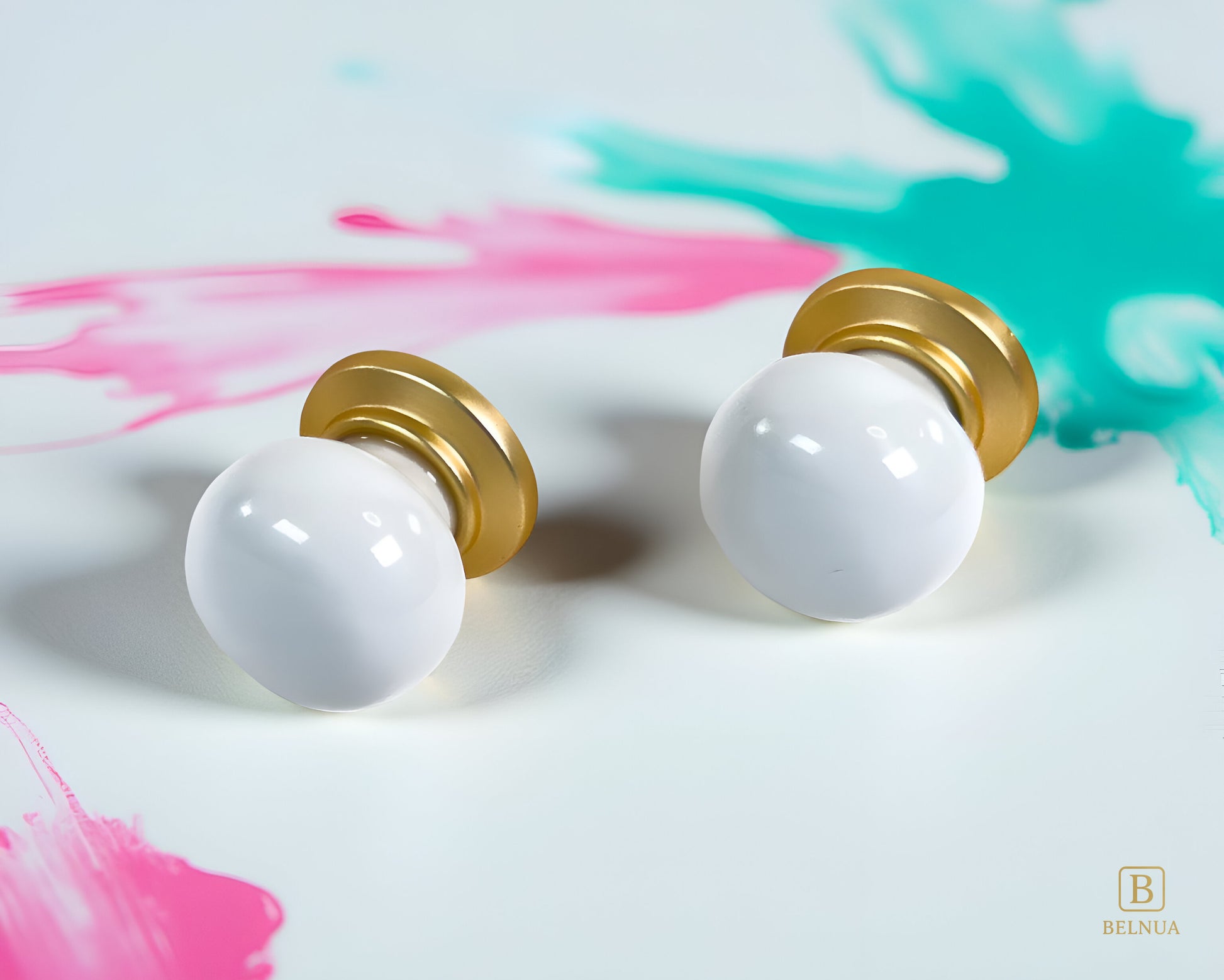 Pair of Zerra porcelain knob with gold base on colourful abstract background | Belnua