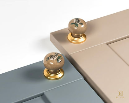 Belnua - ZERRA porcelain/ceramic tan knob pair with elegant rose motif on dusty blue & stone beige cabinet door showcase