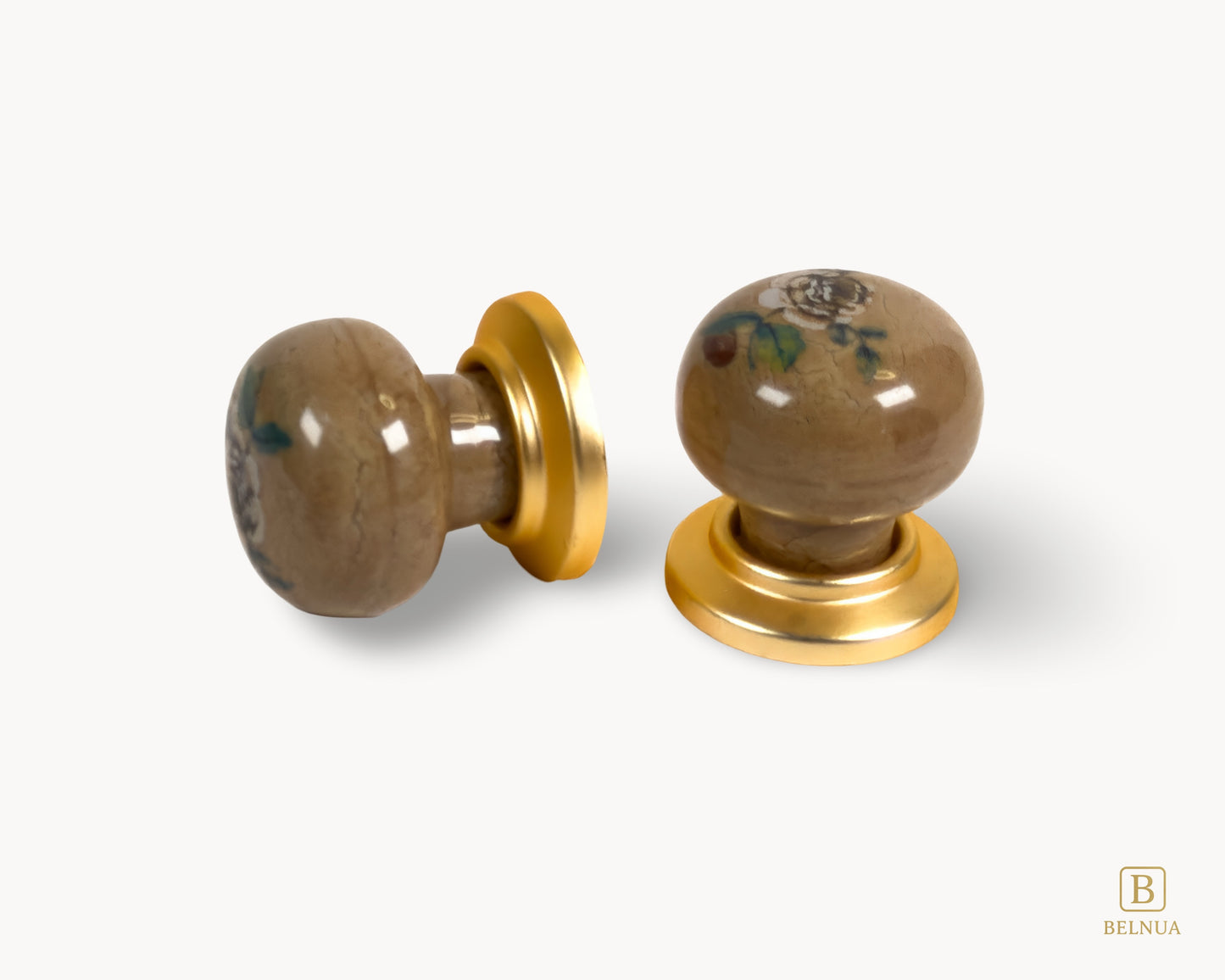 Belnua - Flay lay angled and top view of ZERRA ceramic/porcelain knobs showing pair matte gold finish and rose motif