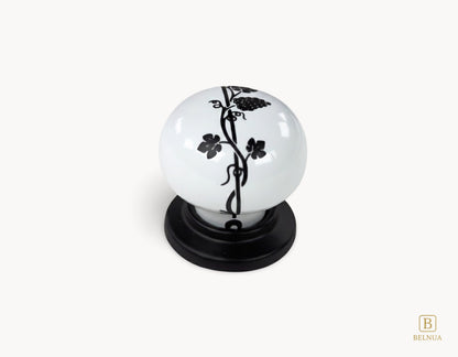 Belnua - Top close up view of Zerra knob with white porcelain featuring black leaf