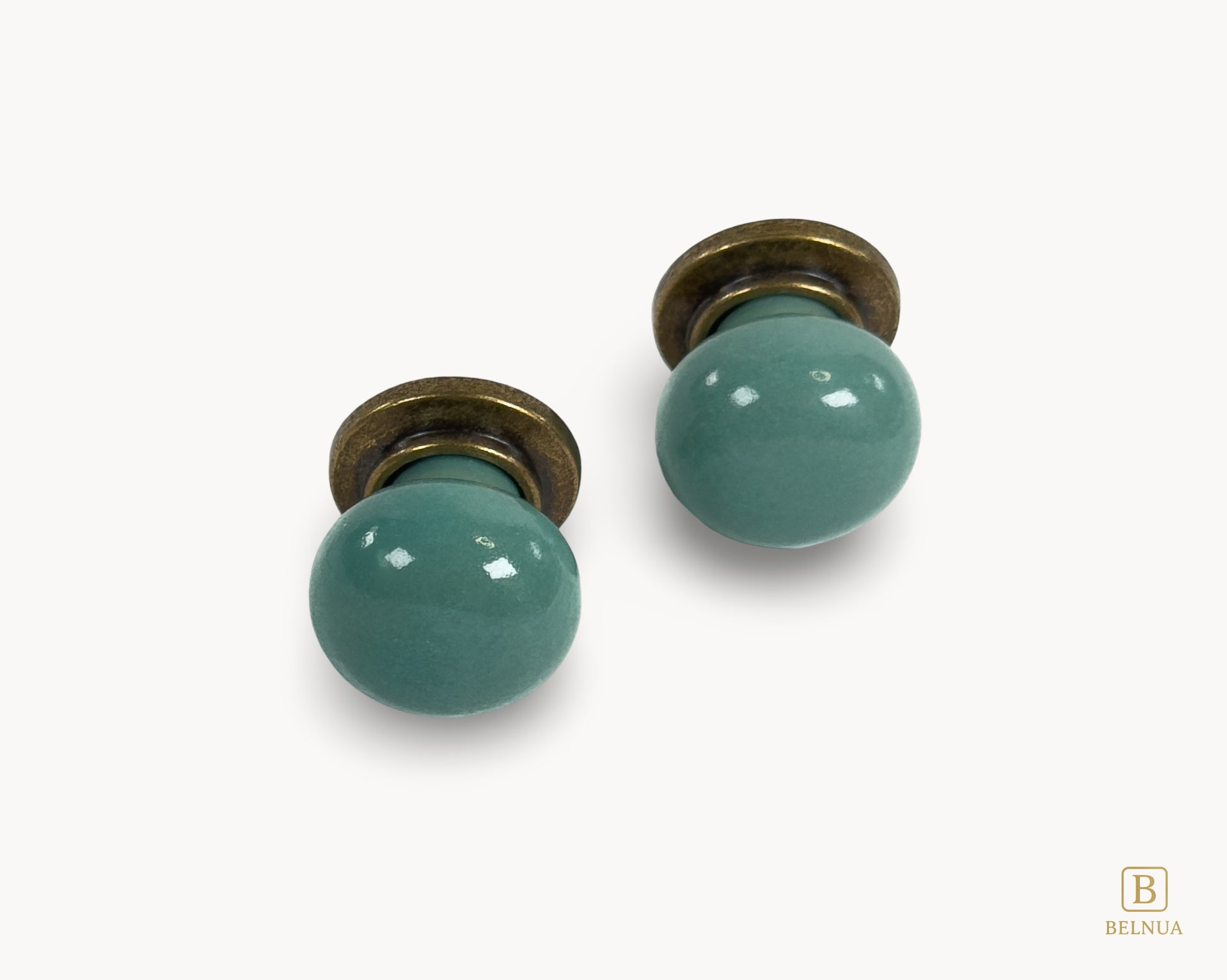 Front flat lay view of Zerra turquoise ceramic cabinet knobs with brass hardware | Belnua