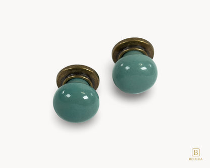 Front flat lay view of Zerra turquoise ceramic cabinet knobs with brass hardware | Belnua
