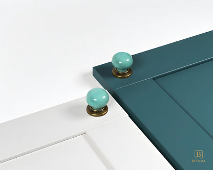 Porcelain white and teal cabinet with turquoise knobs with brass base from Zerra colelction | Belnua