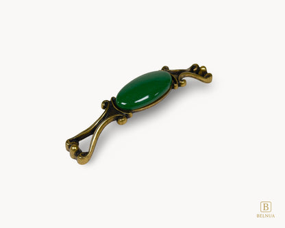 Belnua - Left angled view of Nureya decorative cabinet handle with dark green porcelain and brass base  on white surface
