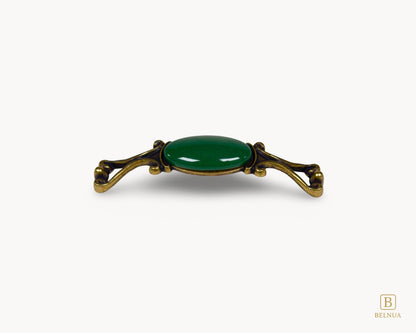 Belnua - Front view of Nureya decorative cabinet handle with dark green porcelain and brass base  on a white surface