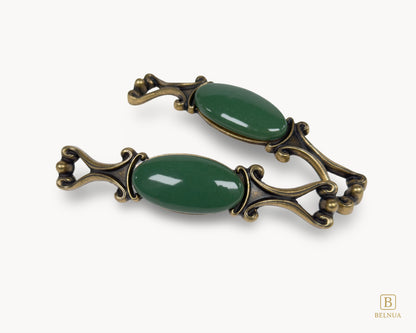 Belnua - Top and front view of Nureya decorative cabinet handle pair with dark green porcelain and brass base  on a white surface